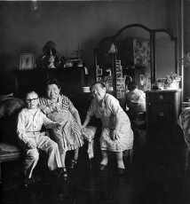 Russian midget friends in a leaving room on 100th Street, by Diane Arbus (1963)