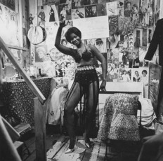Exotic dancer dancing in dressing room by Diane Arbus (1960)
