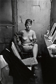 Stripper with bare breasts sitting in her dressing room, Atlantic City by Diane Arbus (1961)