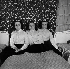 Triplets in their bedroom, N.J. by Diane Arbus (1963)