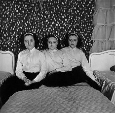 Triplets in their bedroom, N.J. by Diane Arbus (1963)