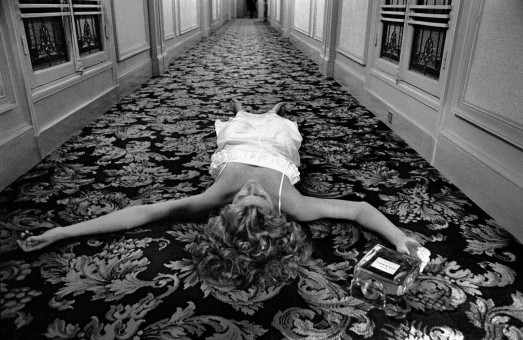 Hitchcock issue, Chris O'Connor lying on the floor, in empty corridor by Frank Horvat (1974)