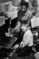 Family Crowds Around Open Oven for Warmth, Harlem, New York by Gordon Parks (1967)