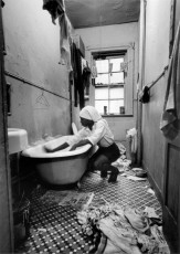 Rosie Fonetenelle Cleans the Bathtub, Harlem, New York by Gordon Parks (1967)