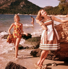 Two young women wearing fashionable swimwear on a beach by Paul Popper (1961)