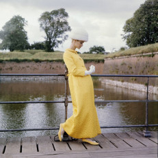 Model standing on planks beside moat at Kronberg, Denmark by Horst P. Horst (1964)