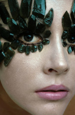 Model wearing Linde Created Emeralds eye ornaments by Union Carbide by Gianni Penati (1968)